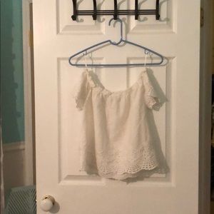 Off the shoulder, small, white shirt.